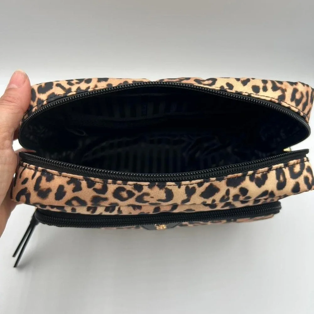 Victoria's Secret Leopard print makeup bag with black stripes interior.